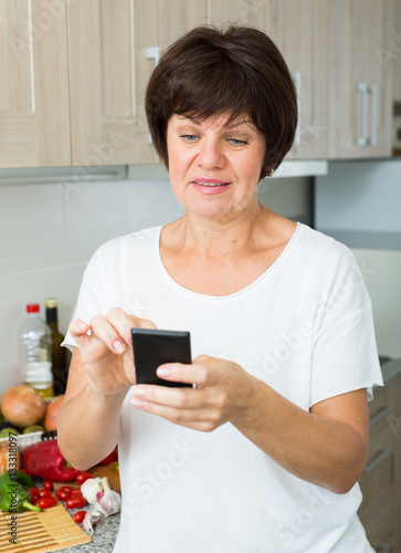 senior woman looking phone