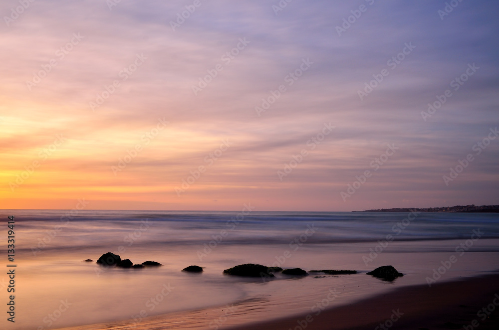 Sunset panorama on the beach, sea on background, long exposure shot.