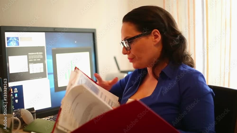 Pretty businesswoman reading documents sitting on home office
Pretty businesswoman reading documents sitting on home office