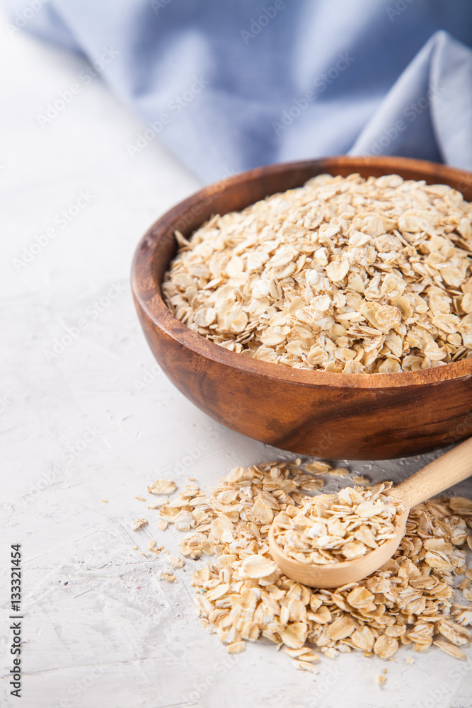 Oat flakes in a bowl on a table, selective focus, copy space Oat flakes in a bowl on a table, selective focus, copy space