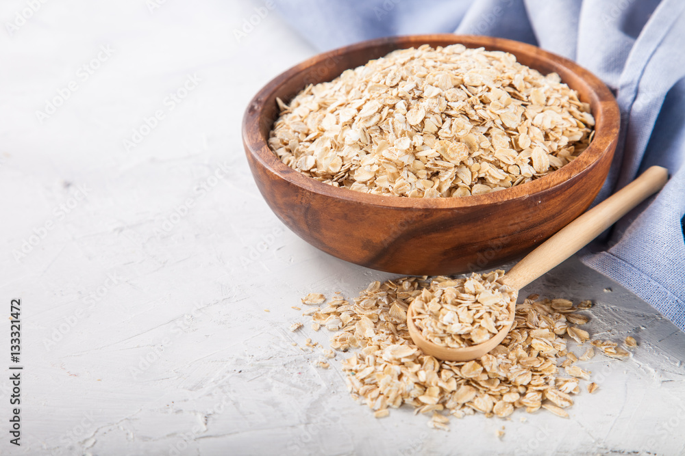 Oat flakes in a bowl on a table, selective focus, copy space Oat flakes in a bowl on a table, selective focus, copy space