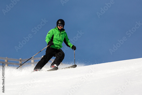 Male skier skiing on ski slope