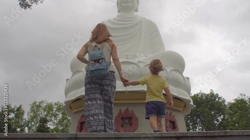 Young woman on a stairs to Big Budha in LongSon Pagoda. Nhga Trang. Vietnam photo