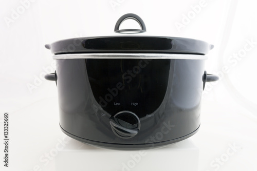 Fotografie Isolated black crock pot slow cooker with lid. Horizontal.