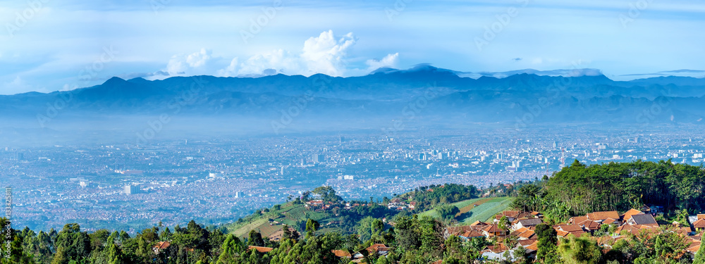 Panorama view of little village on top of the hill and scenery of bandung city from faraway, captured  from Moko Hills when weather is sunny, Bandung, Indonesia