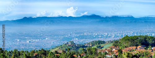 Panorama view of little village on top of the hill and scenery of bandung city from faraway, captured from Moko Hills when weather is sunny, Bandung, Indonesia