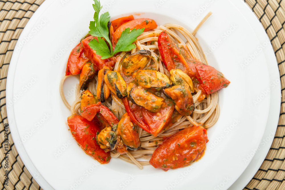 white dish with spaghetti, mussel and tomatoes white dish with spaghetti, mussel and tomatoes