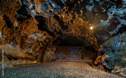 Beautiful floor and brown cave wall in cave passage, illuminated by yellow lamp,  Captured from Lawa cave, Purbalingga, Indonesia. photo