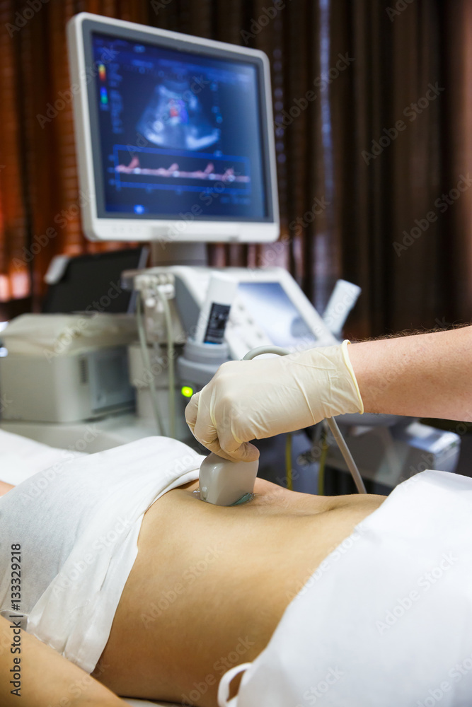 Doctor doing an ultrasound on a patient abdomen
