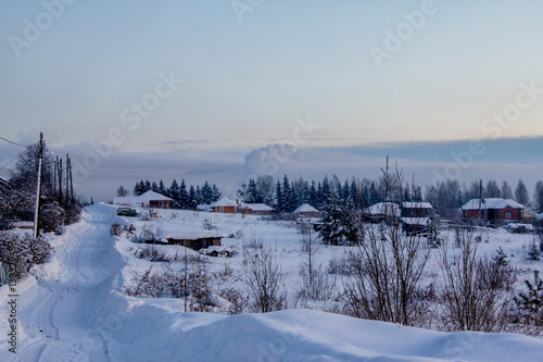 rustic cabins nestled in snow on a cold winter evening