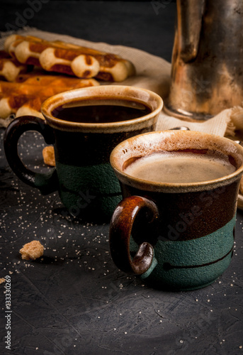 Homemade breakfast, a cozy kitchen, stone table. Viennese waffles, two cups of coffee, coffee, vintage spoon with brown sugar, Close view, copy space