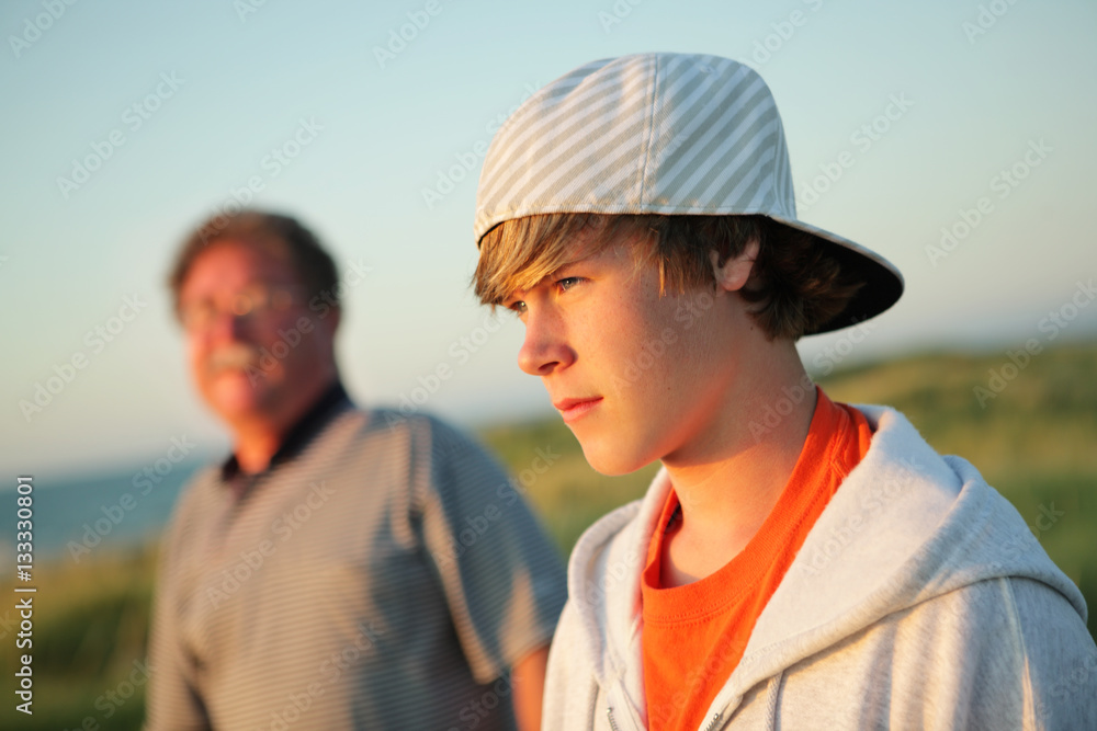 Serious teen with father