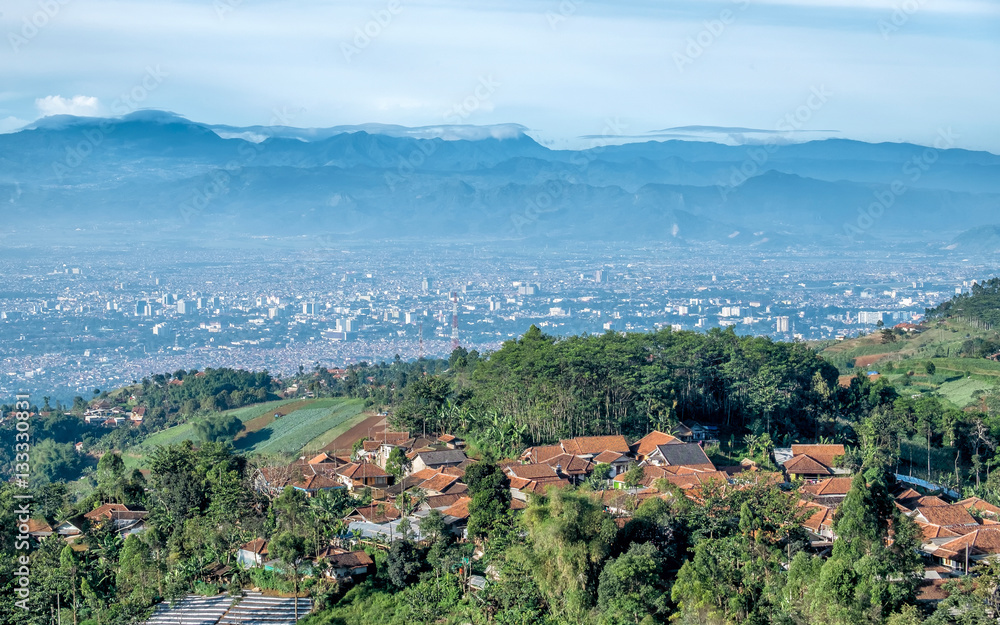 Little village on top of the hill and scenery of bandung city from faraway, captured  from Moko Hills when weather is sunny, Bandung, Indonesia