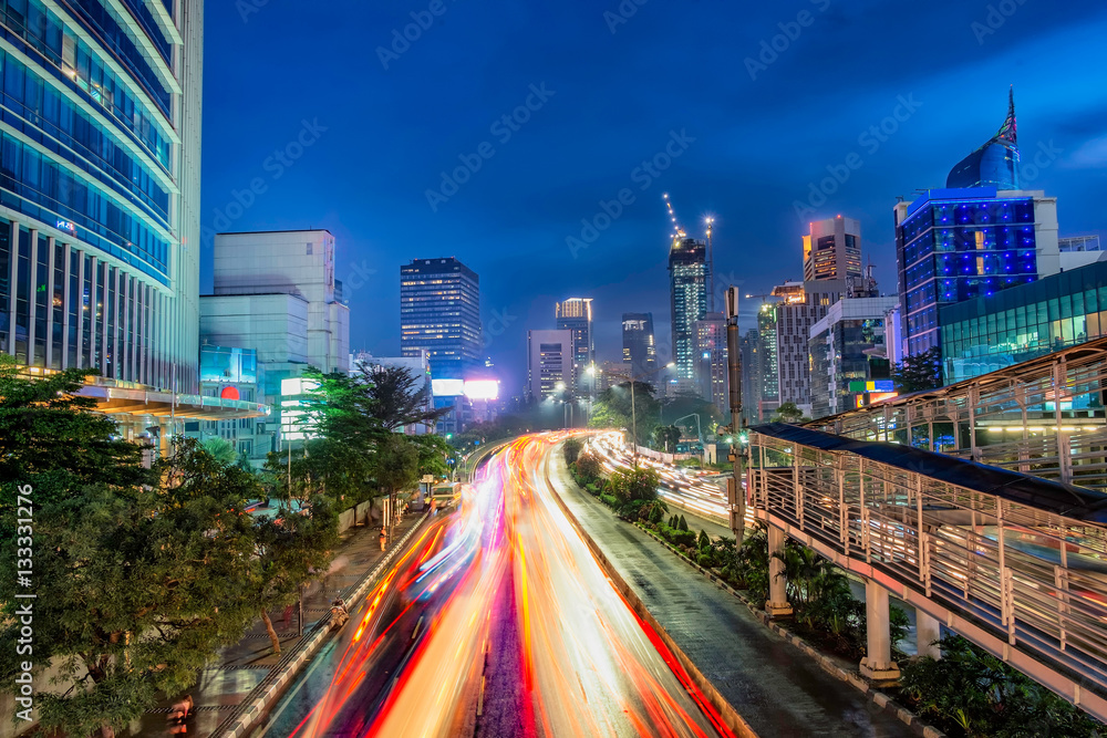 Φωτογραφία Iconic skyline and heavy traffic in Sudirman Street, Jakarta, Indonesia at dusk, showing light trail  of busy traffic and iconic skyscrapers in Jakarta