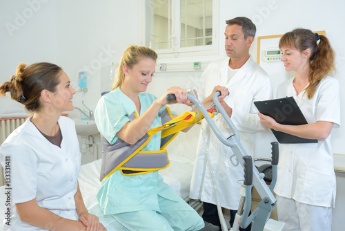 Patient being hoisted from bed