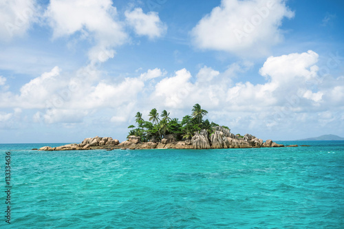 little Island with palm trees with granite rocks in the ocean