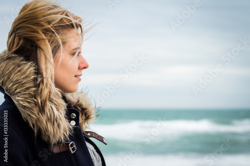 Girl on the background of the sea close-up. Space for text