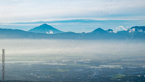Aerial view of city and mountain when illuminated by sunlight in faraway, captured from Moko Hills when weather is sunny, Bandung, Indonesia