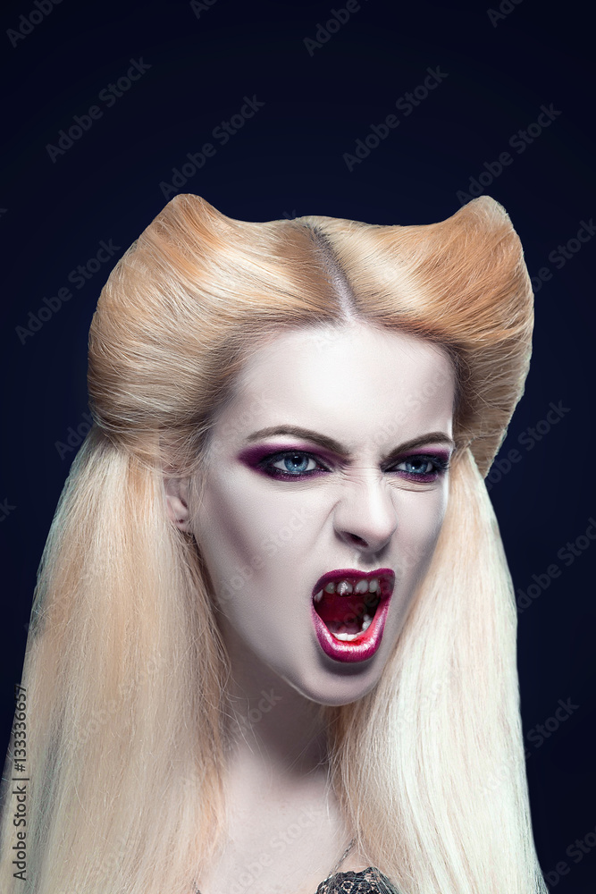 Beautiful blonde girl vampire with blood is on the mouth and eyes. Amazing  hairstyle Stock Photo | Adobe Stock