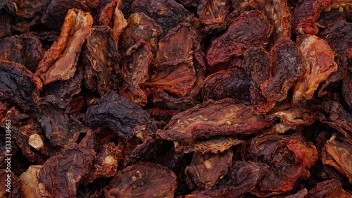 Sun dried tomatoes in the farmers market. Texture background.