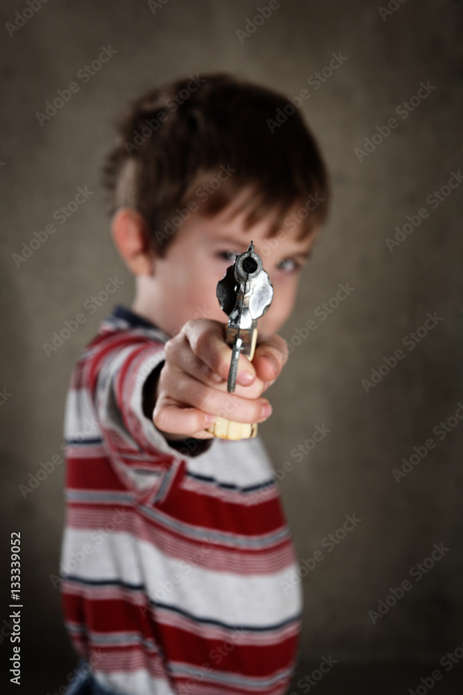Φωτογραφία Boy aiming toy gun, shallow focus