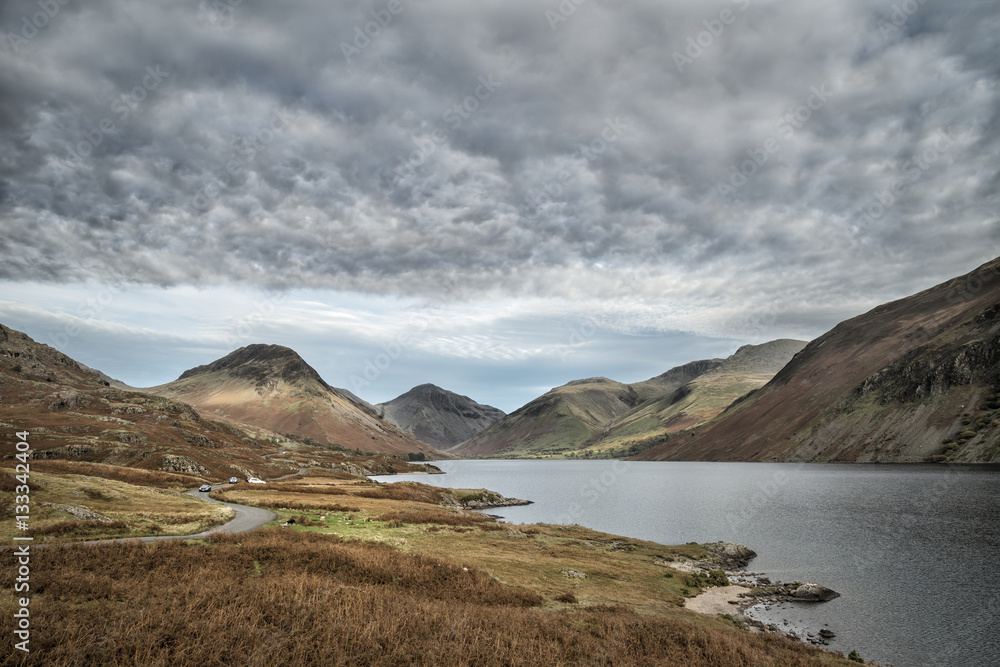 Beautiful sunset landscape image of Wast Water and mountains in