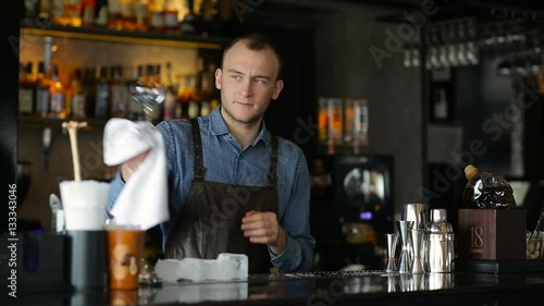 Wallpaper Mural The bartender wiping glasses behind the bar Torontodigital.ca