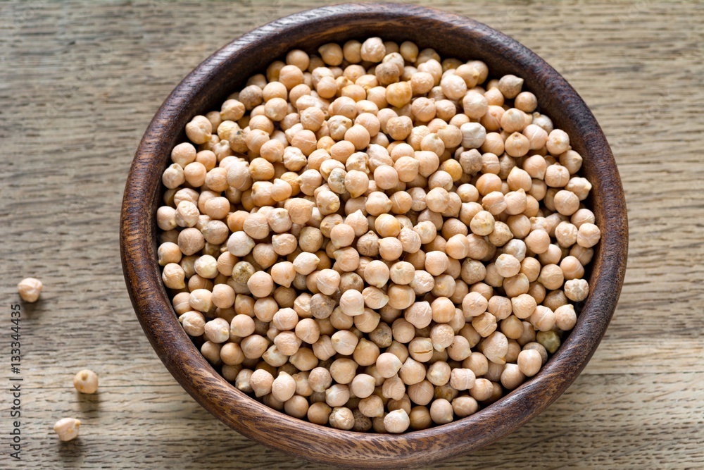 Healthy organic product Chickpeas in wooden bowl. Vegan cooking, indian cuisine Healthy organic product Chickpeas in wooden bowl. Vegan cooking, indian cuisine