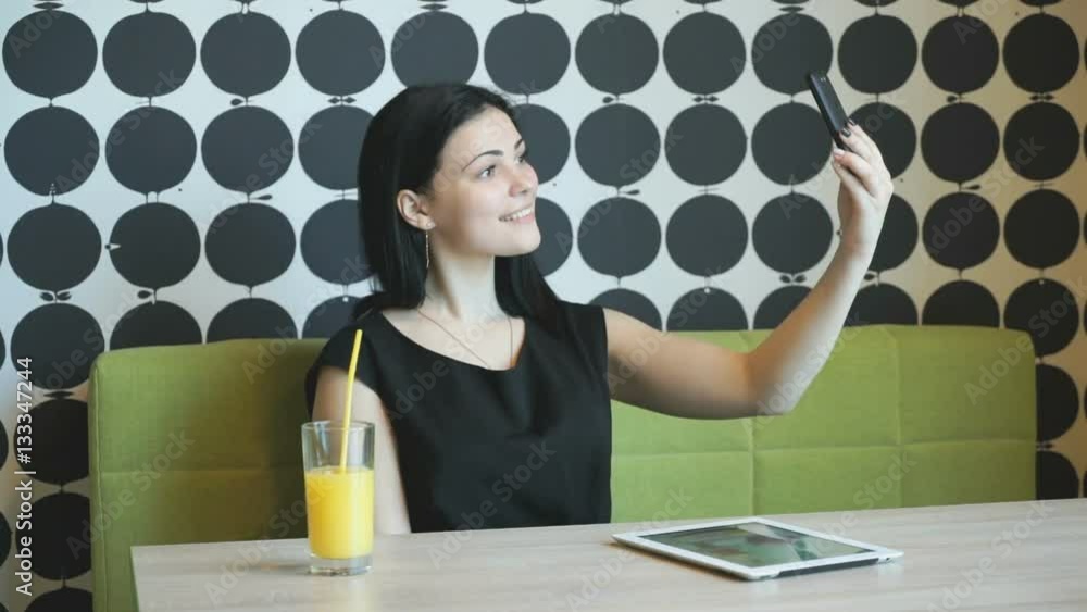 Young attractive model girl aged 20s making selfie photo using a smartphone indoors Young attractive model girl aged 20s making selfie photo using a smartphone indoors