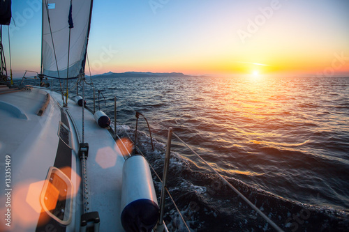 Yacht at sailing regatta at the sea during sunset. Luxury boats.