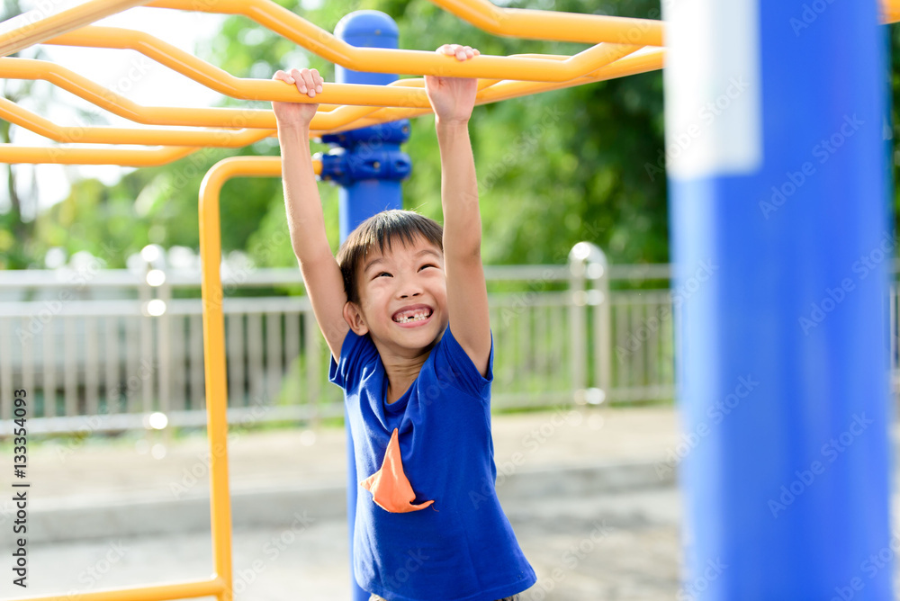 Fototapeta premium Young boy play with yellow bar