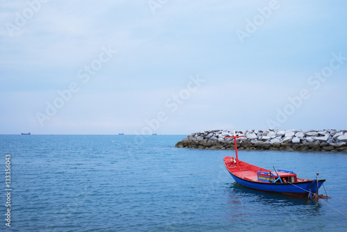 Fishing boat on the sea under blue sky