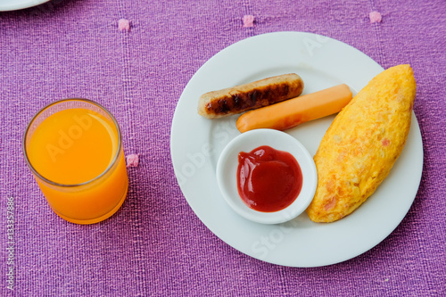 Omelette with bacon, sausage and oragne juice