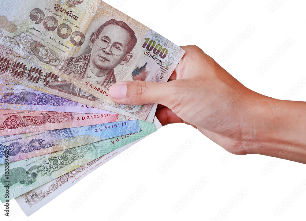 Hand holding thai money isolated on white background