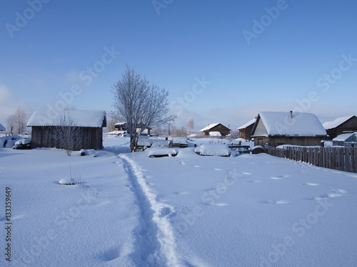 Rural winter landscape houses with footpath in snow © skymoon13