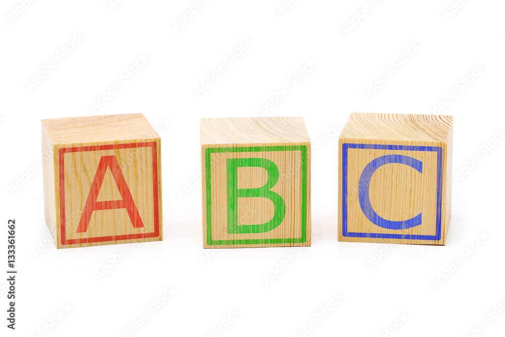 ABC letters on three brown wooden cubes lined up ABC letters on three brown wooden cubes lined up