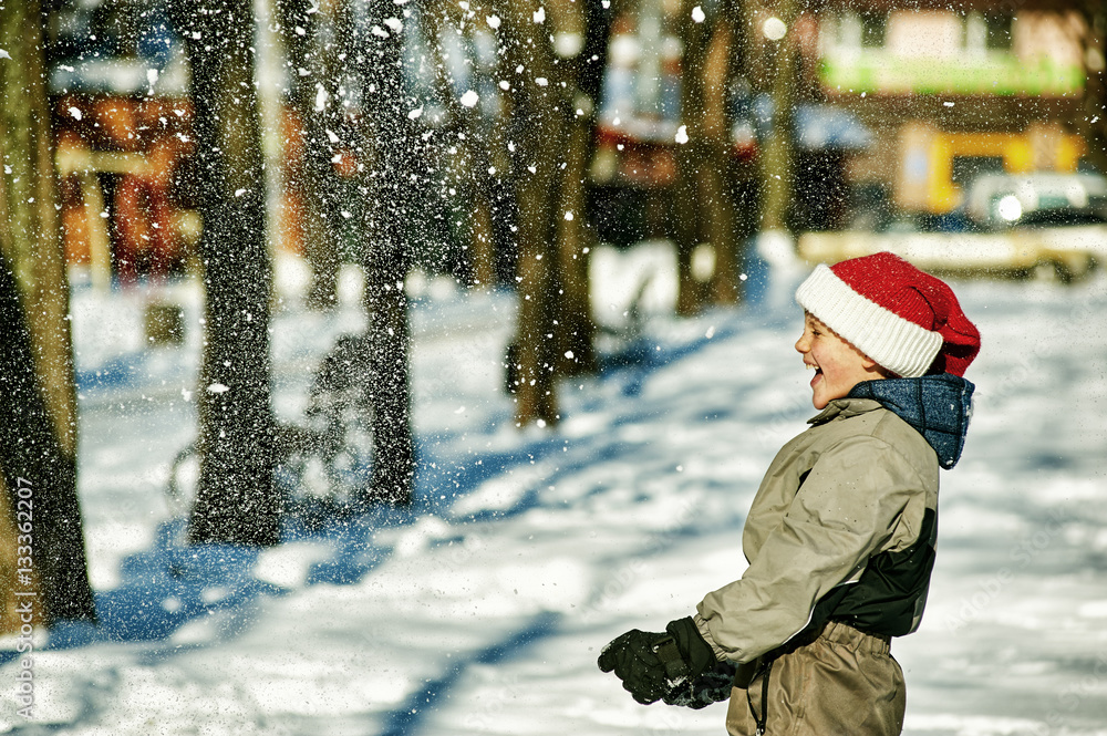 Happy boy playing with snow Happy boy playing with snow