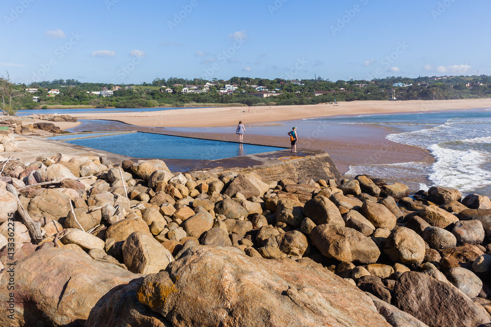 Women Exploring Beach Tidal Pool Landscape Stock-Foto | Adobe Stock
