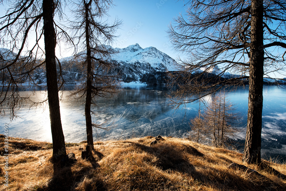 Frozen mountain lake in winter sunny day