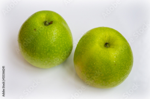 Fresh green apple fruits on white background