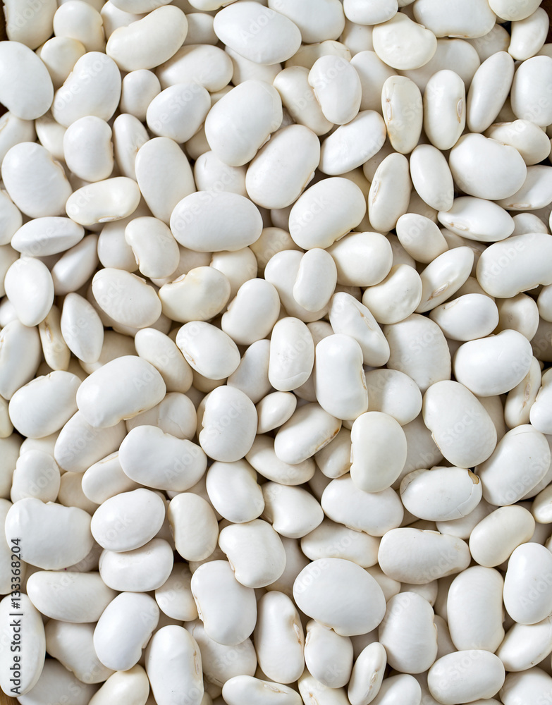 white butter beans on wooden surface white butter beans on wooden surface