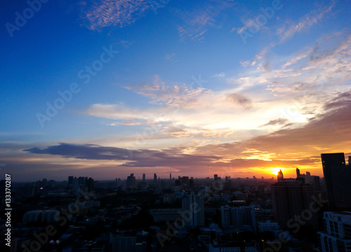 Texture of bright evening sky during sunset with city foreground