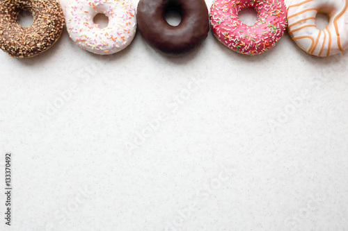 Donuts in color glaze on a light background.