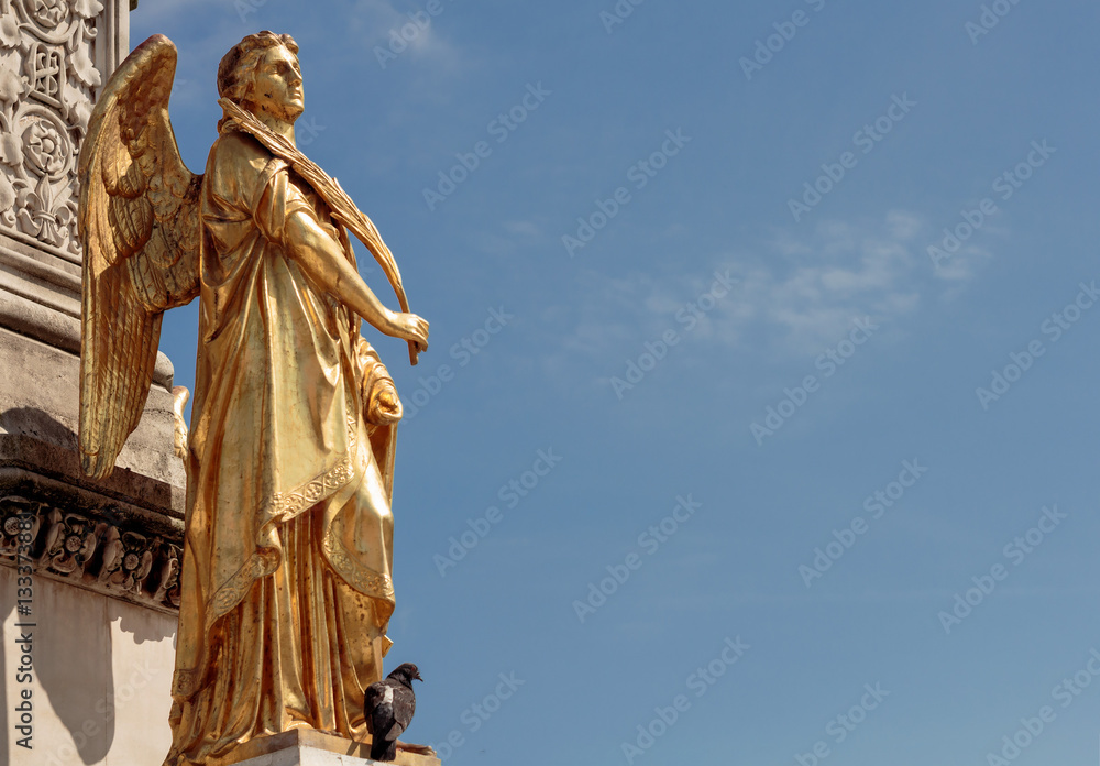 Fototapeta premium Gold Angel sculpture, fountain in front of cathedral in Zagreb, Croatia