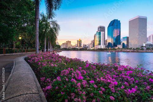 Cityscape photography of Benchakitti Park at twilight time in Bangkok, Thailand. Outdoor evening landscape of modern city skyscrapers in Asia