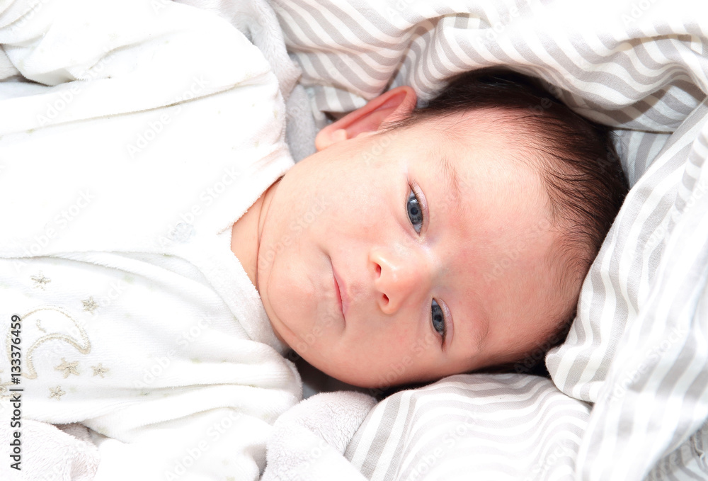 Sweet two months old blue eyed little baby's portrait.