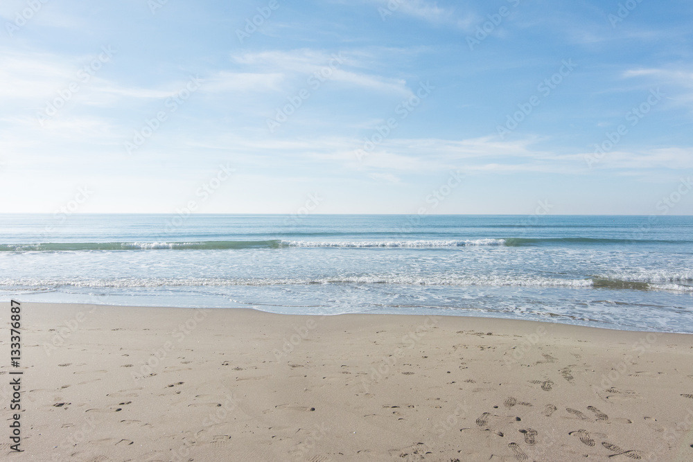 waves, sea and sun reflecting from the beach - background