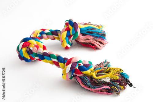 Colorful cotton dog toy on a white background