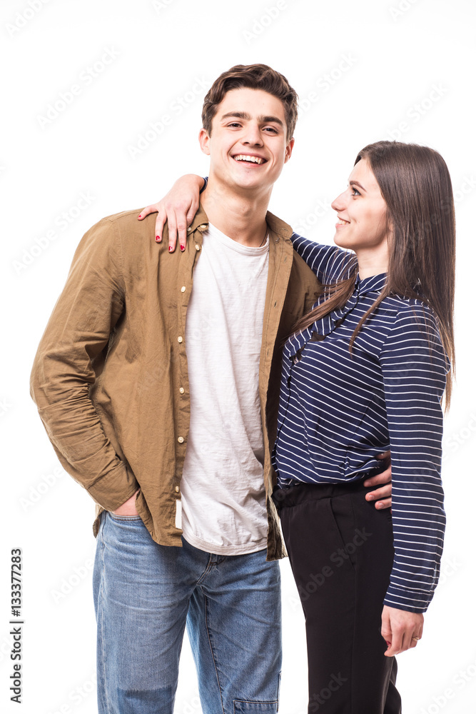 Portrait of beautiful smiling couple hug at studio over white background.