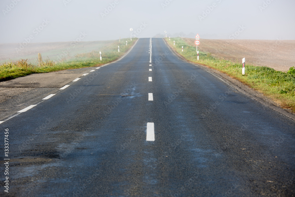 Fototapeta premium Empty long highway with fog